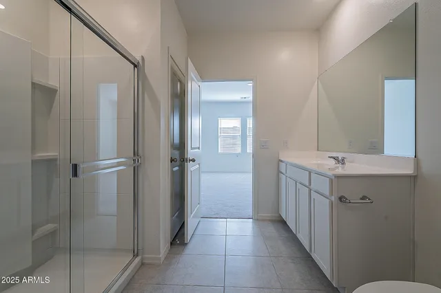 a bathroom with a double vanity sink and a mirror
