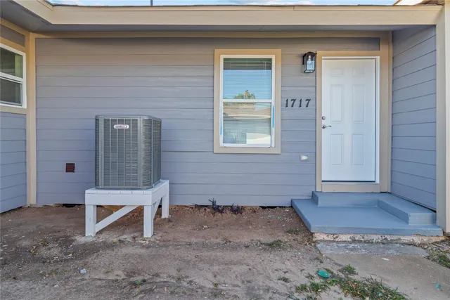 a view of backyard with a chair and front door