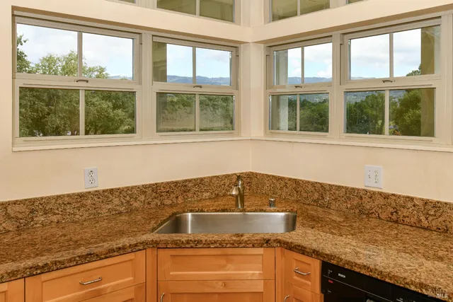 a kitchen with granite countertop a sink and a window