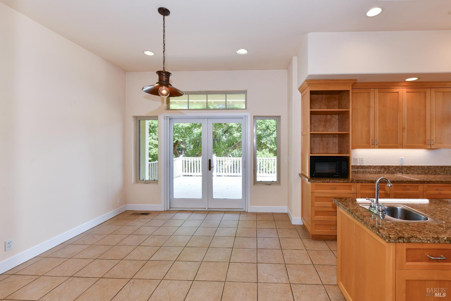 1219 Repetto Ranch Road Sonoma, CA 95476 - Photo 14 of 54 a kitchen with granite countertop a sink and a stove