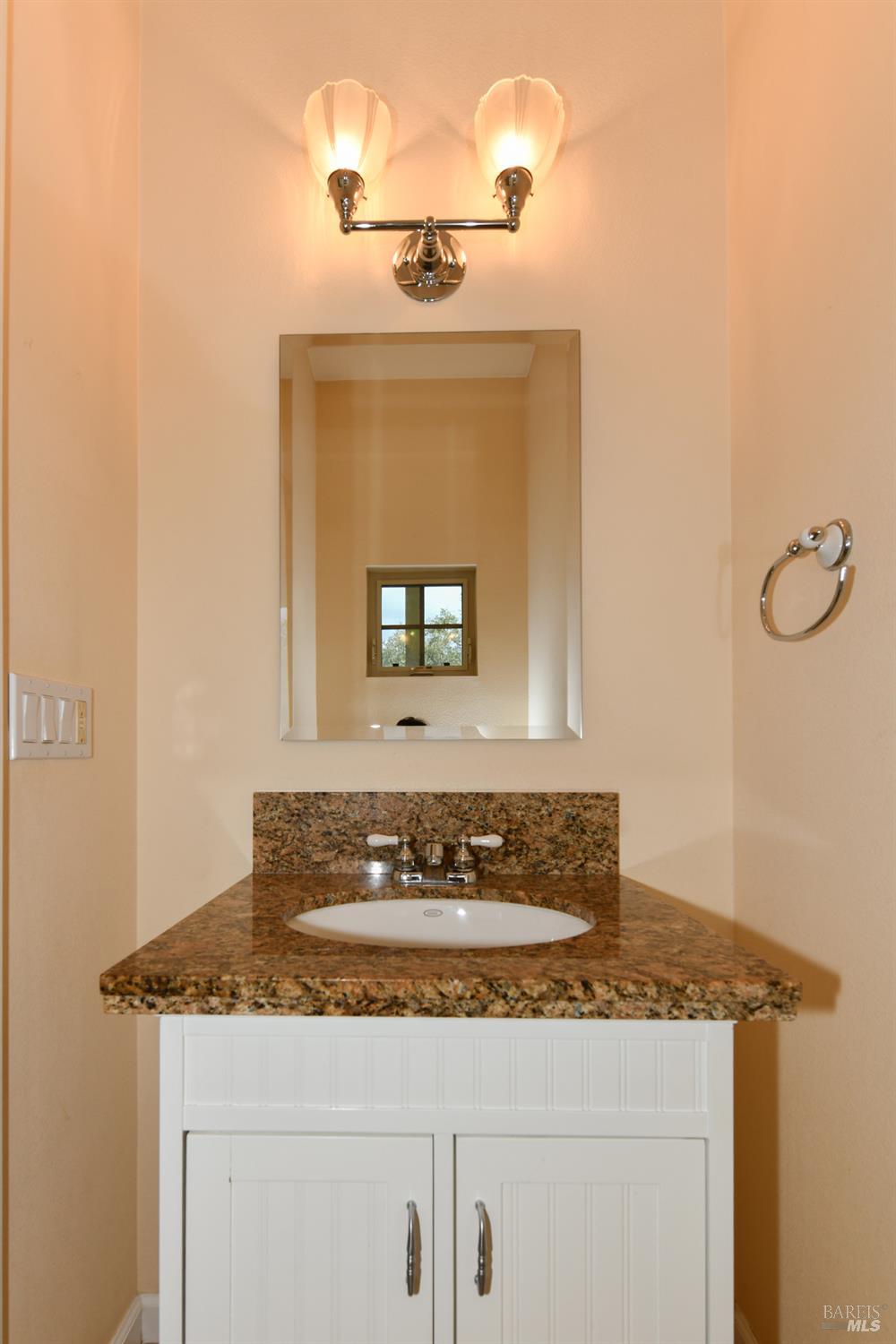 1219 Repetto Ranch Road Sonoma, CA 95476 - Photo 18 of 54 a bathroom with a granite countertop sink and mirror