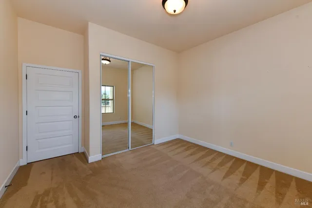 an empty room with closet area