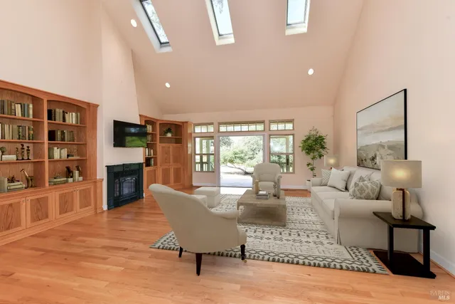 a living room with fireplace furniture and a wooden floor