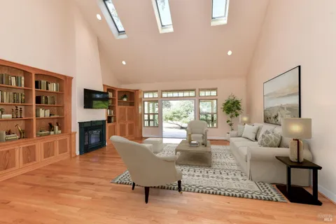 a view of empty room with wooden floor and windows