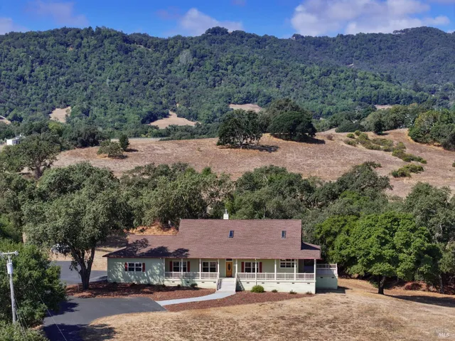 an aerial view of a house with mountain view