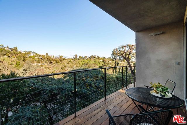 a view of a balcony with mountain view and wooden floor