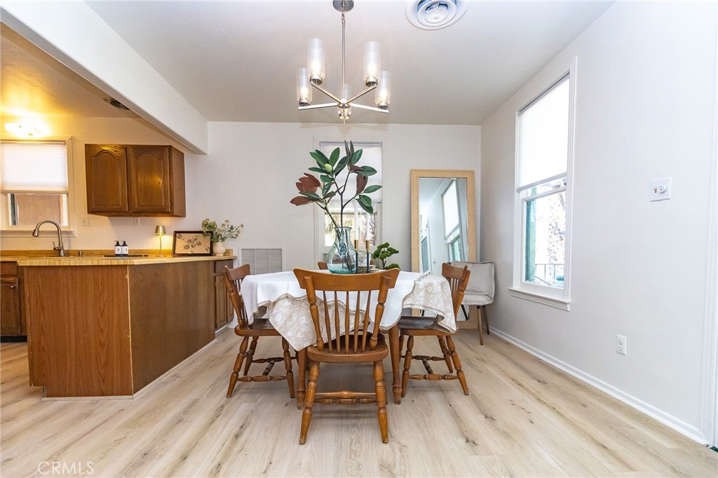 411 Bazoobuth Street Needles, CA 92363 - Photo 12 of 71 a dining room with furniture a window and wooden floor