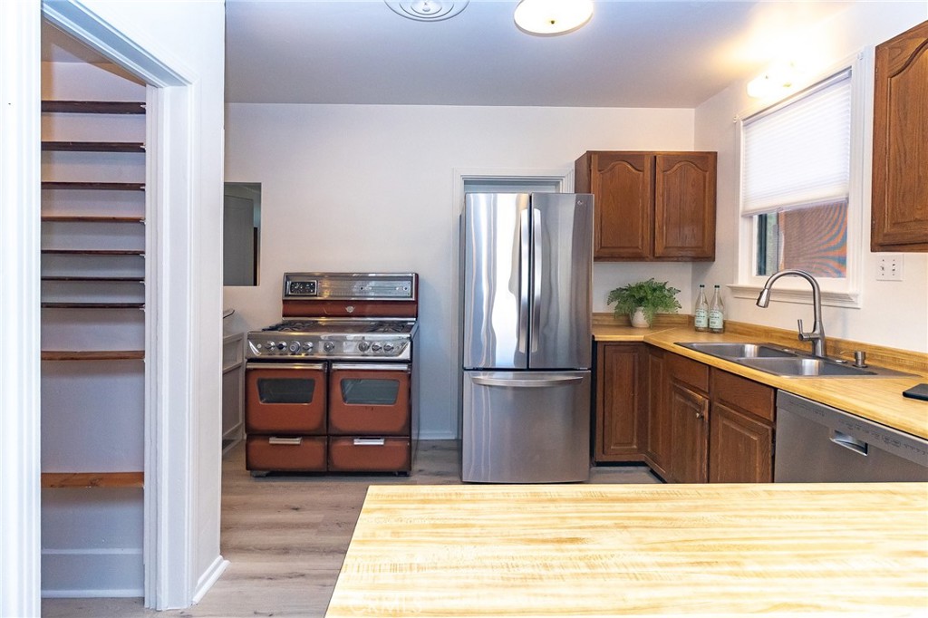 411 Bazoobuth Street Needles, CA 92363 - Photo 15 of 71 a kitchen with kitchen island a sink stainless steel appliances and cabinets