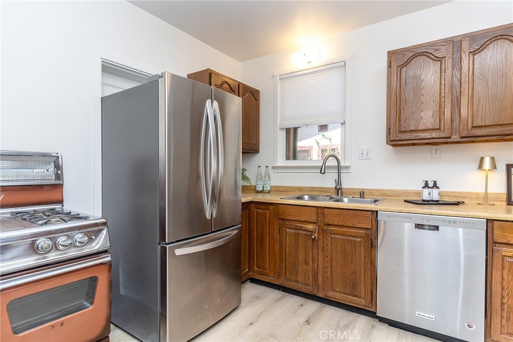 411 Bazoobuth Street Needles, CA 92363 - Photo 17 of 71 a kitchen with stainless steel appliances granite countertop a refrigerator stove and sink