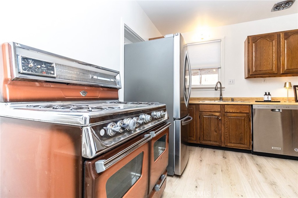 411 Bazoobuth Street Needles, CA 92363 - Photo 19 of 71 a kitchen with a stove and a sink