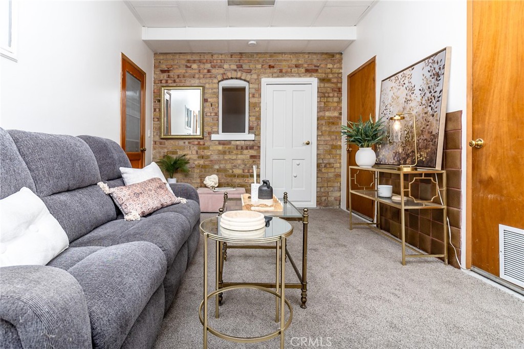 411 Bazoobuth Street Needles, CA 92363 - Photo 41 of 71 a living room with furniture a table and a painting