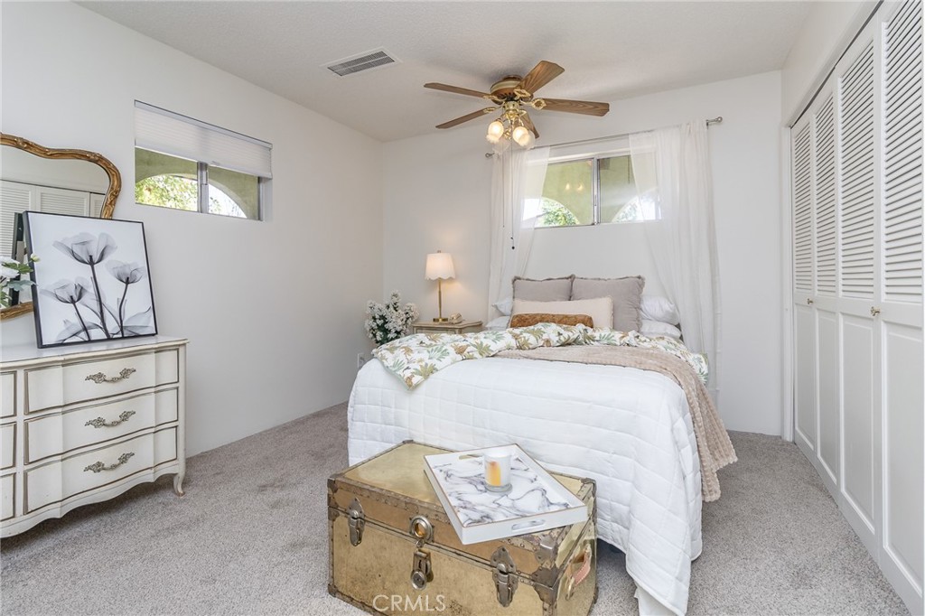 411 Bazoobuth Street Needles, CA 92363 - Photo 45 of 71 a bedroom with a bed and a chandelier