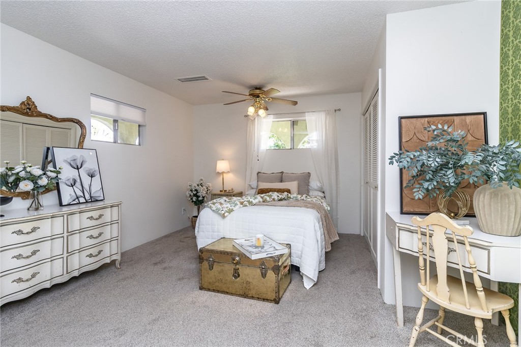411 Bazoobuth Street Needles, CA 92363 - Photo 47 of 71 a bedroom with a bed and a chandelier