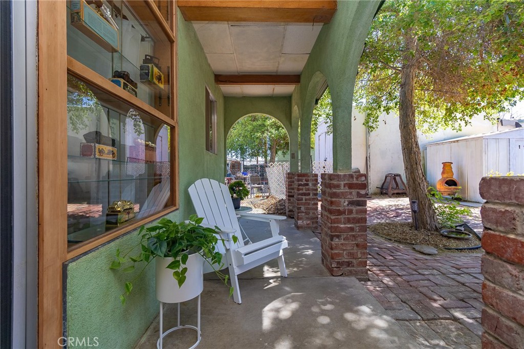 411 Bazoobuth Street Needles, CA 92363 - Photo 56 of 71 a view of a porch with chairs and potted plants
