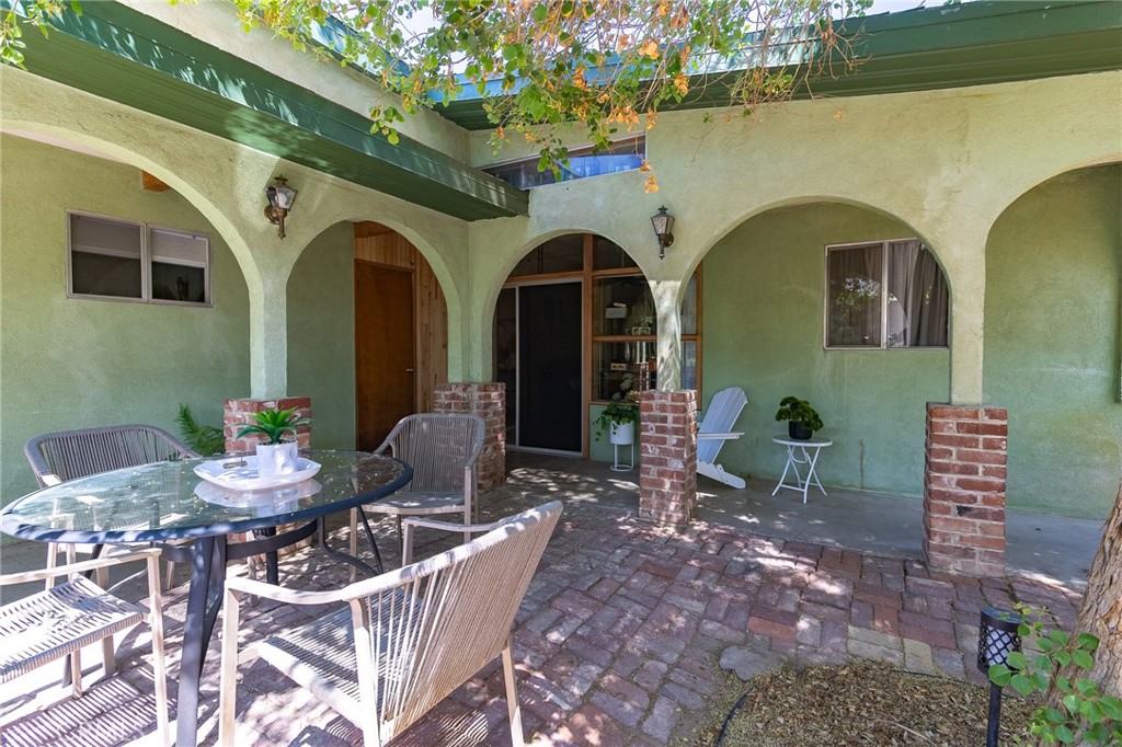 411 Bazoobuth Street Needles, CA 92363 - Photo 58 of 71 a front view of a house with outdoor seating
