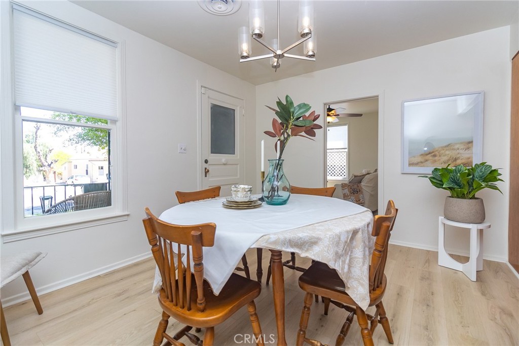 411 Bazoobuth Street Needles, CA 92363 - Photo 9 of 71 a dining room with furniture potted plants and wooden floor