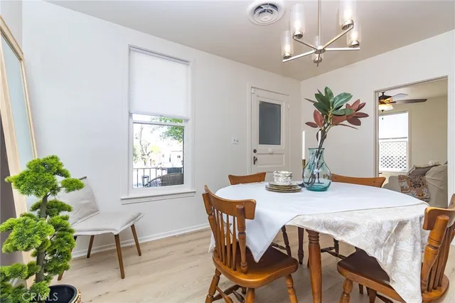 a room with kitchen island a potted plant a refrigerator and a stove
