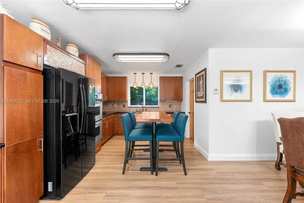 a dining room with furniture a rug and wooden floor