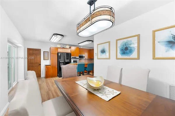 a view of a dining room and hall with furniture