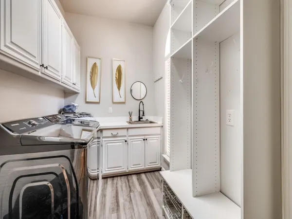 a view of a sink and washer dryer