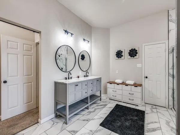 a room with a baby crib and a mirror