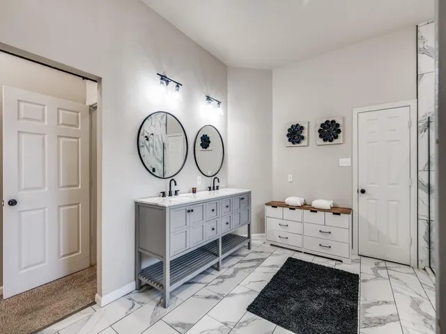 a room with a baby crib and a mirror