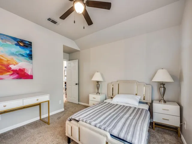 a bedroom with a bed and a lamp