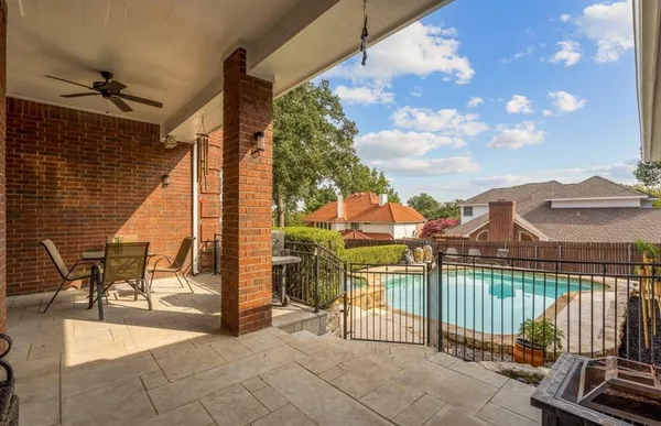 a view of a patio with a table and chairs