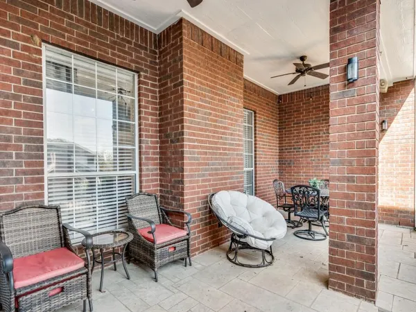 a view of a chairs and table in patio
