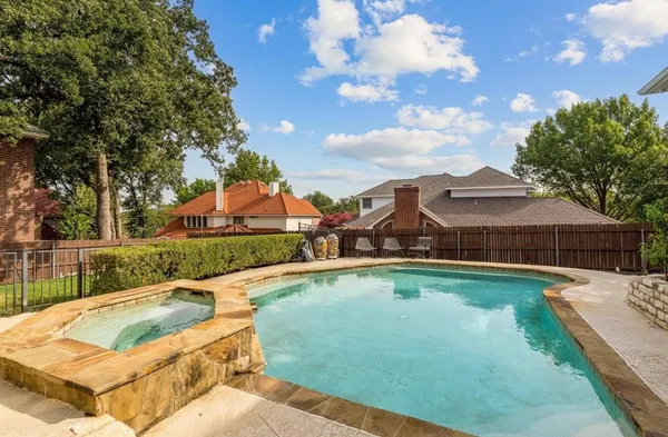 a view of a house with swimming pool and sitting area