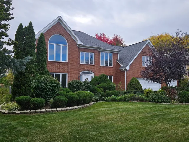 a front view of a house with a yard