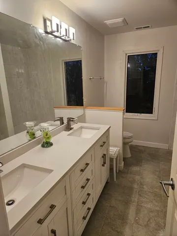 a bathroom with a sink double vanity and a mirror