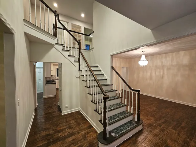 a view of entryway with wooden floor and stairs