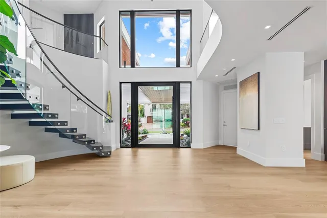 a kitchen with stainless steel appliances a stove top oven a sink a chimney and a large window