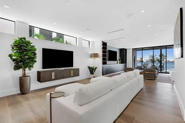 a living room with furniture and view of kitchen
