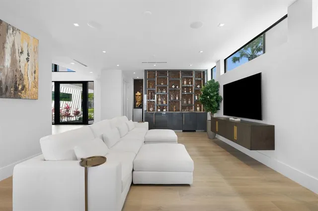 a living room with furniture a large window and a table