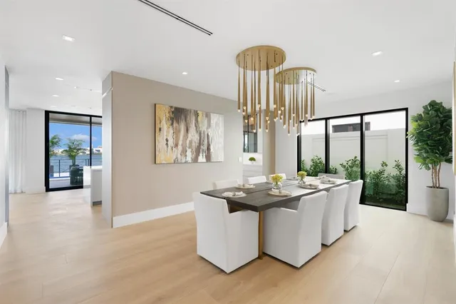 a large white kitchen with a large window