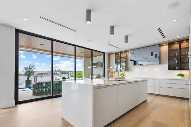 a living room with furniture chandelier and a fireplace