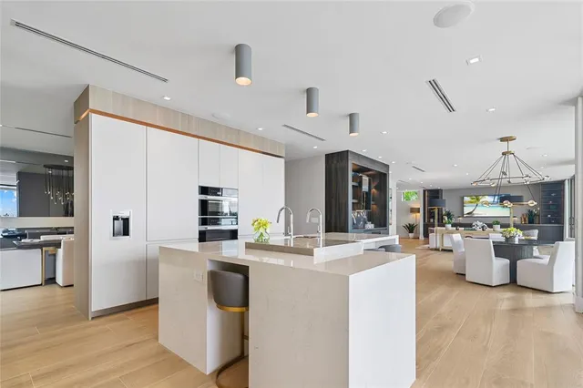 a living room with couch a dining table and chairs