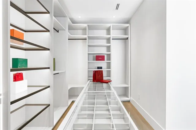 a bedroom with a bed large window and couch