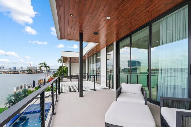 a view of a livingroom with wooden floor and a ceiling fan