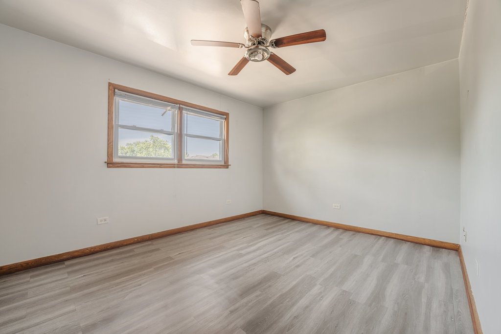 3756 West 120th Street, Unit 3A Alsip, IL 60803 - Photo 13 of 27 an empty room with wooden floor ceiling fan and windows
