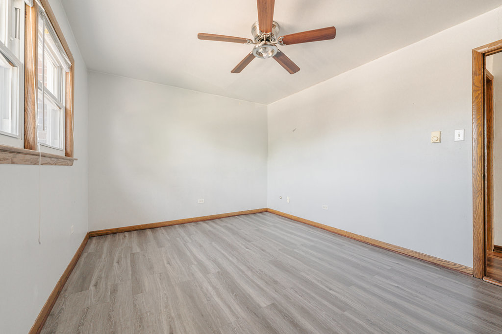 3756 West 120th Street, Unit 3A Alsip, IL 60803 - Photo 14 of 27 an empty room with wooden floor fan and windows