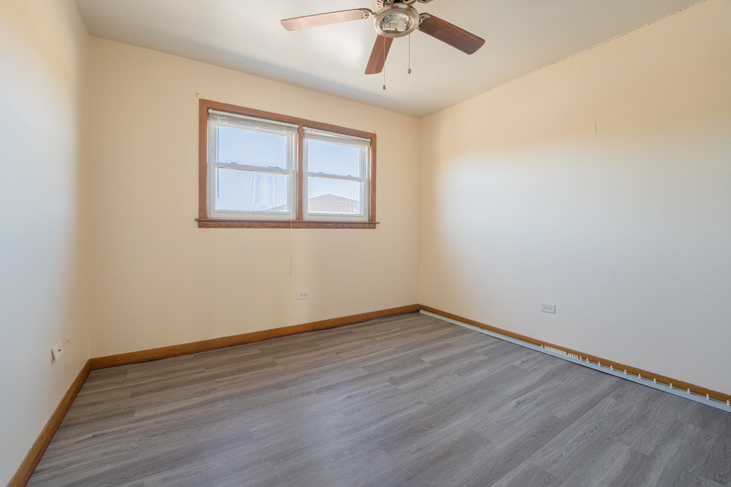 3756 West 120th Street, Unit 3A Alsip, IL 60803 - Photo 15 of 27 a view of an empty room with wooden floor and a window