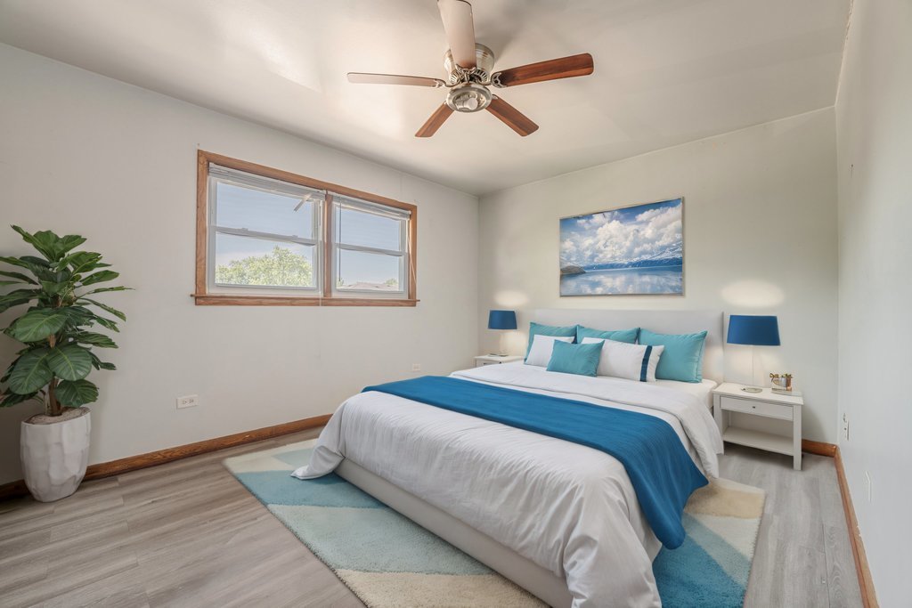 3756 West 120th Street, Unit 3A Alsip, IL 60803 - Photo 5 of 27 a bedroom with a large bed chandelier and a window