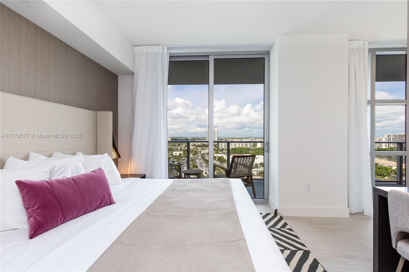 4010 South Ocean Drive, Unit R2204 Hollywood, FL 33019 - Photo 16 of 22 a bedroom with a large bed and a large window