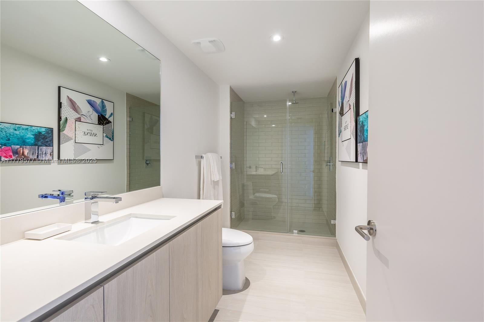 4010 South Ocean Drive, Unit R2204 Hollywood, FL 33019 - Photo 19 of 22 a bathroom with a sink a toilet and shower