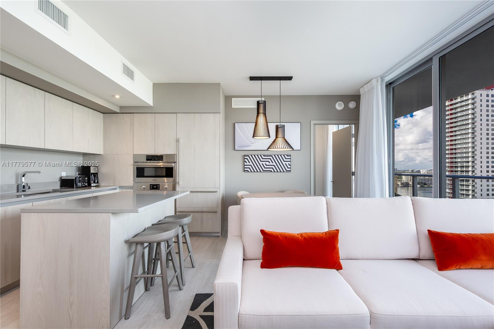 4010 South Ocean Drive, Unit R2204 Hollywood, FL 33019 - Photo 7 of 22 a living room with stainless steel appliances furniture a large window and a kitchen view