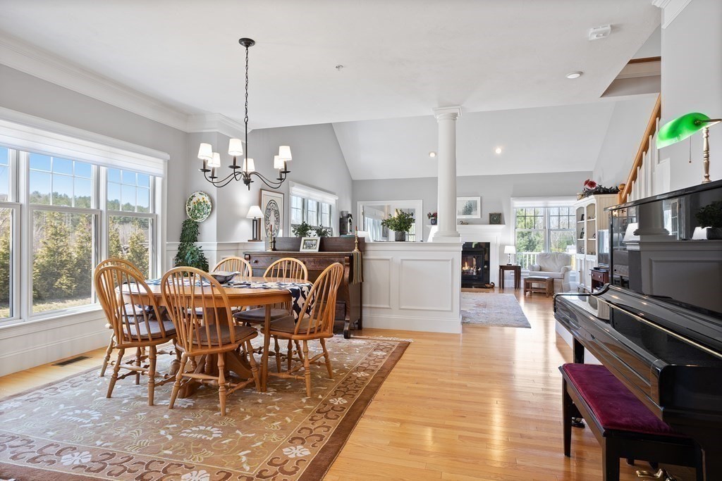 31 Sauta Farm Way, Unit 16 Hudson, MA 01749 - Photo 18 of 41 a dining room with furniture a chandelier and wooden floor