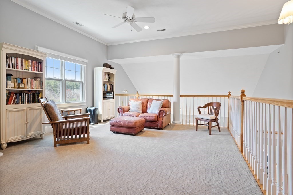 31 Sauta Farm Way, Unit 16 Hudson, MA 01749 - Photo 31 of 41 a bedroom with furniture and a book shelf